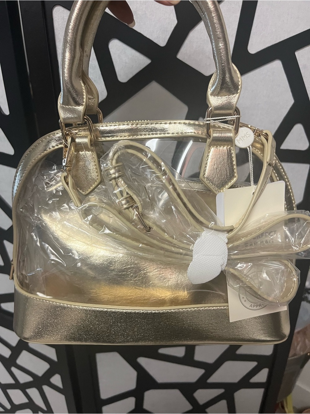 Gold clear two and one purse with handles and gold straps.